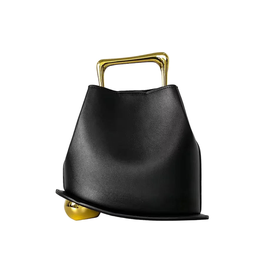 Black handbag with gold accents on a light gray background
