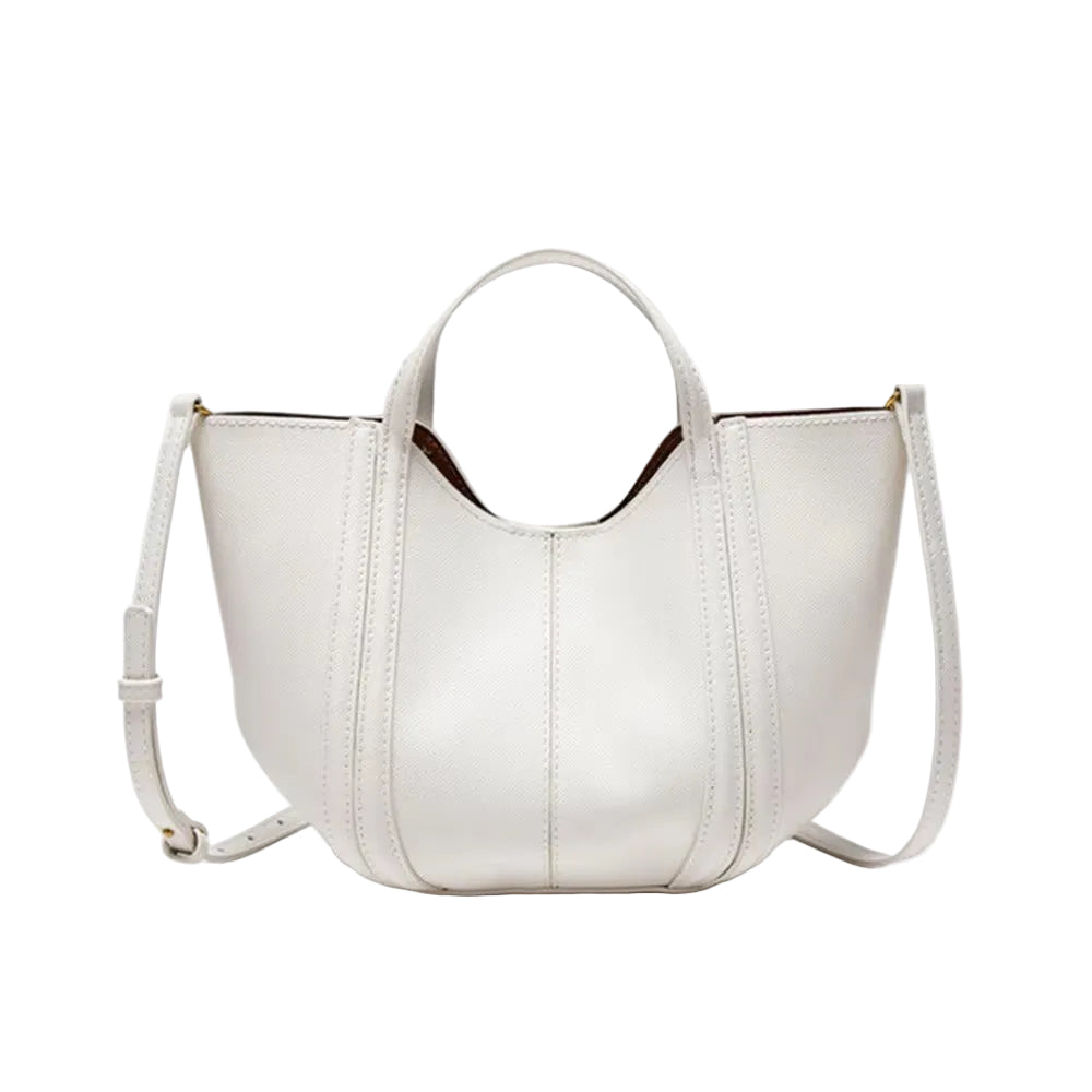 A white faux-leather handbag with top handles and a shoulder strap, shown on a light gray background with a speech bubble indicating an included leopard-print ribbon.