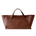 Brown leather tote bag on a white background